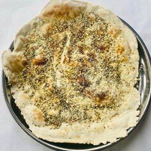 Warm flatbread with sesame and herbs